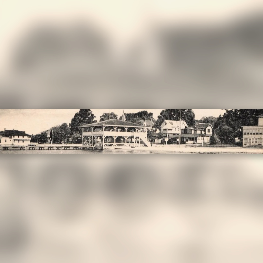 Historic panoramic photograph showing the waterfront pavilion centered among nearby buildings